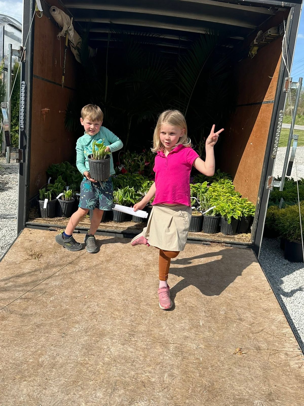 Two of the little ones unloading hostas from the trailer