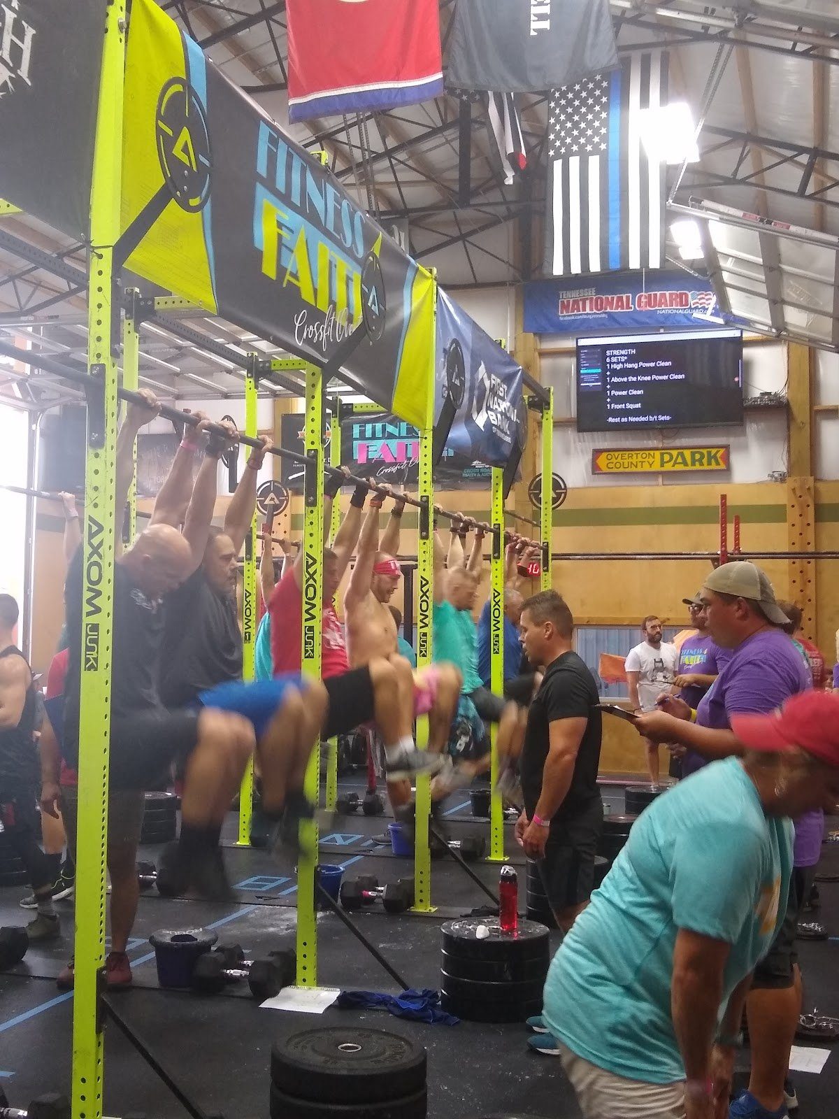 A group class in progress on the gym floor at Muscle Factory Group Fitness