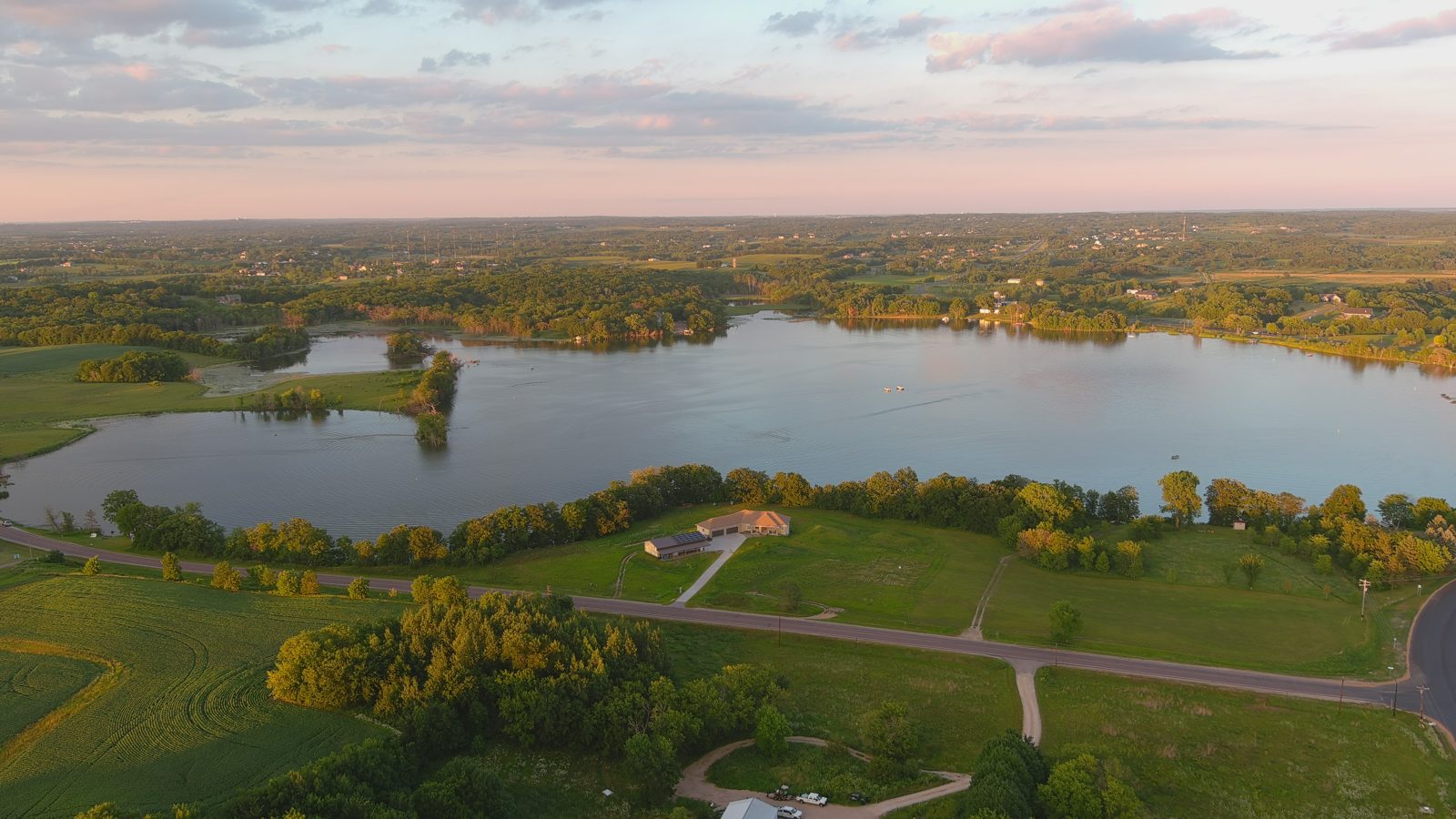 Golden-hour aerial over a lake and farmland — Upper Cumberland, Tennessee