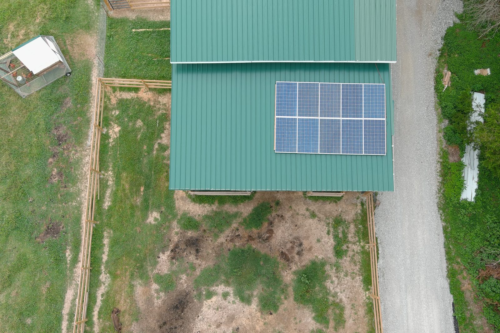 Top-down view of a barn roof with solar panels